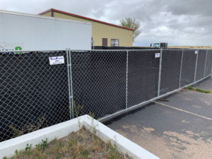 Fence being used for storage in a Denver parking lot