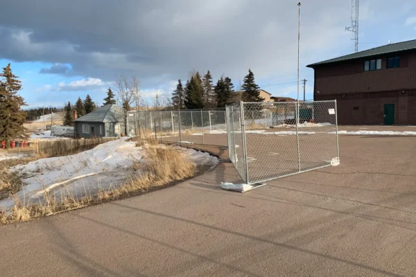 Temporary fence panels installed at a winter construction site